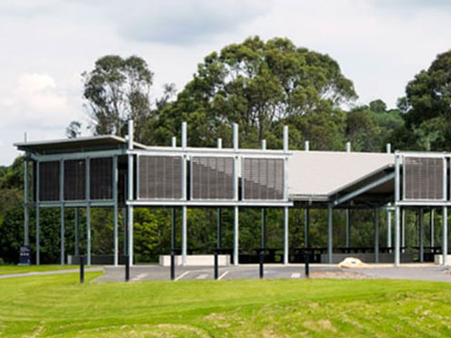 Lawn with pavilion and trees in the background