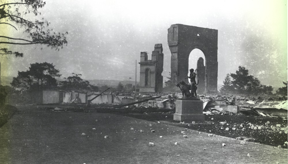 View over the ruins left by the fire on the night of the 22nd September 1882. The statue of the Huntsman & Dog in foreground