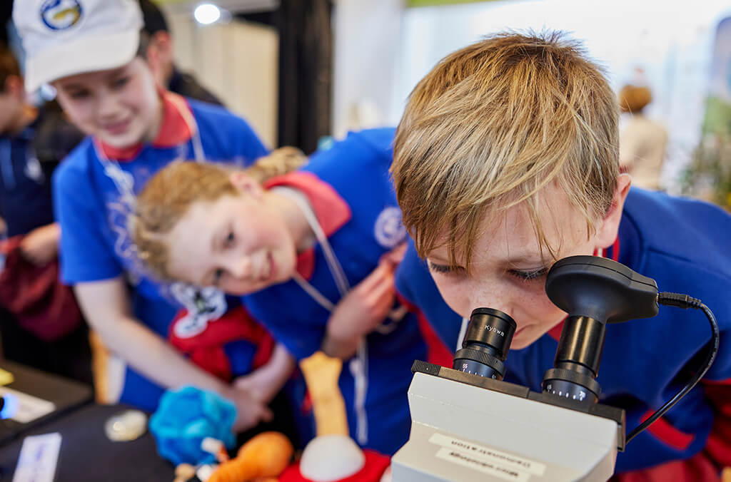 Boy looks through microscope